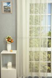 FüggönyFutár Webáruház Ekrü színű, vasalás könnyített, puha szálú fényes félorganza függöny , egyedi méretre, készre varrjuk