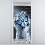 Mivali Fototapeta pentru ușă - fluture albastru în palmă (D013392D95205)