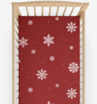 Goldea gyermek körgumis pamut lepedő kiságyba - hópelyhek piros alapon 60 x 120 cm